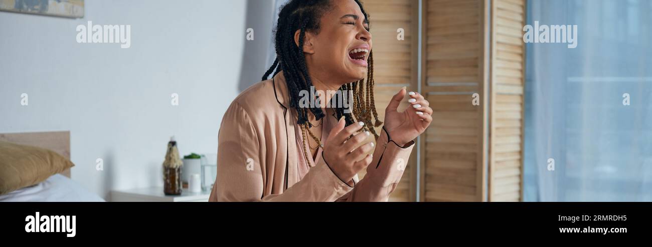 grief, depressed african american woman crying and screaming at home, miscarriage concept, banner Stock Photo