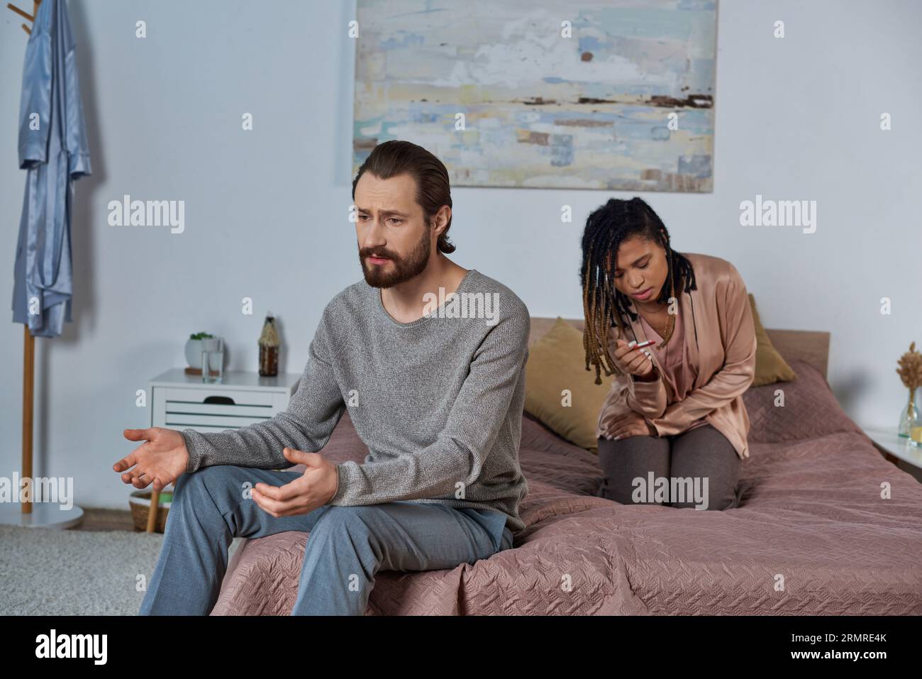 couple making decision, African american woman with pregnancy test, abortion concept, bedroom, talk Stock Photo