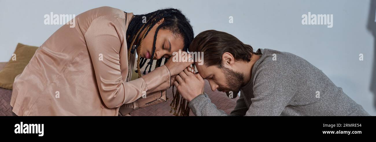 african american woman holding hands with man, worried multicultural couple bonding, empathy, banner Stock Photo