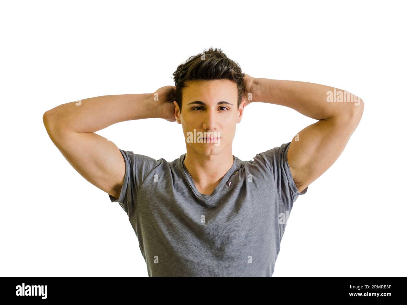 A young handsome man with his hands behind his head in a relaxed pose
