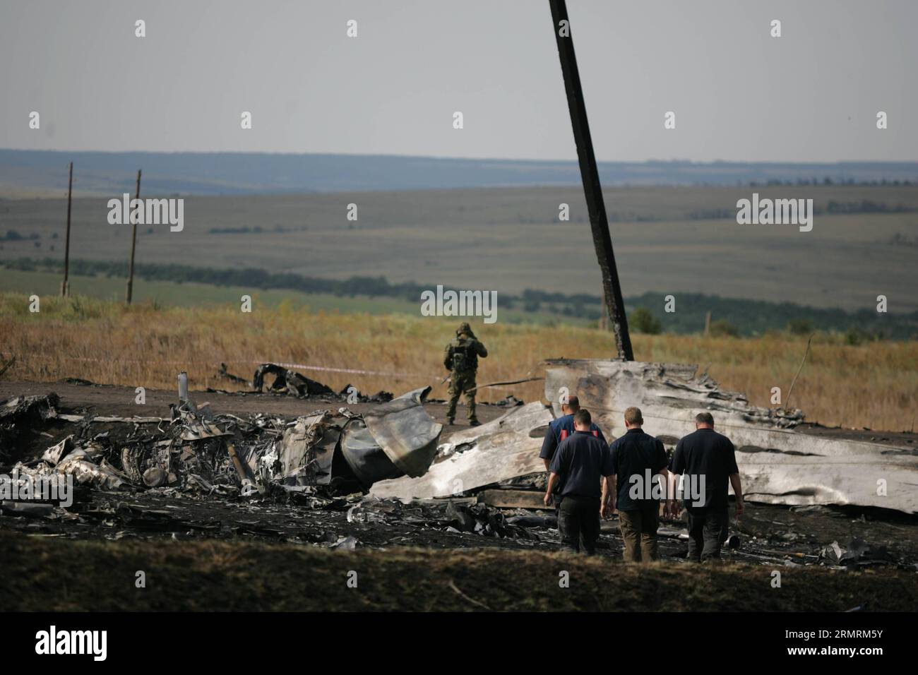 Monitors from the Organization for Security and Cooperation in Europe (OSCE) check debris of the crashed Malaysia Airlines Flight 17 in Donetsk region, Ukraine on July 25, 2014. At the crash site in eastern Ukraine, international experts found more remains and another large piece of the fuselage on Thursday, Michael Bociurkiw, a spokesman for the OSCE, told reporters in Donetsk. (Xinhua/Alexander Ermochenko) UKRAINE-DONETSK-CRASH SITE-INVESTGATION PUBLICATIONxNOTxINxCHN   Monitor from The Organization for Security and Cooperation in Europe OSCE Check debris of The Crashed Malaysia Airlines Fli Stock Photo