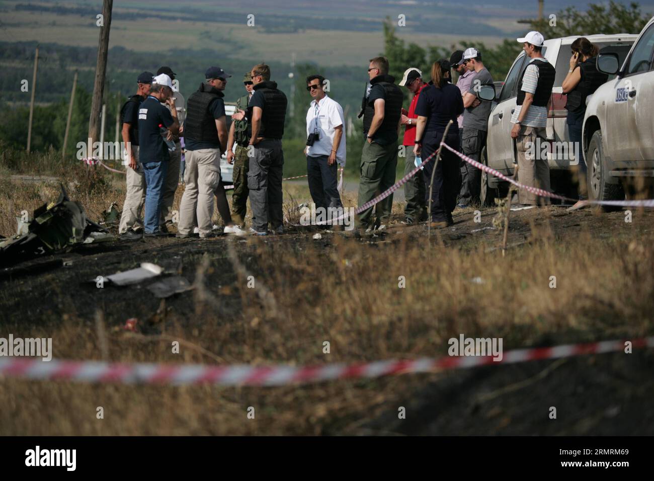 Monitors from the Organization for Security and Cooperation in Europe (OSCE) check debris of the crashed Malaysia Airlines Flight 17 in Donetsk region, Ukraine on July 25, 2014. At the crash site in eastern Ukraine, international experts found more remains and another large piece of the fuselage on Thursday, Michael Bociurkiw, a spokesman for the OSCE, told reporters in Donetsk. (Xinhua/Alexander Ermochenko) UKRAINE-DONETSK-CRASH SITE-INVESTGATION PUBLICATIONxNOTxINxCHN   Monitor from The Organization for Security and Cooperation in Europe OSCE Check debris of The Crashed Malaysia Airlines Fli Stock Photo