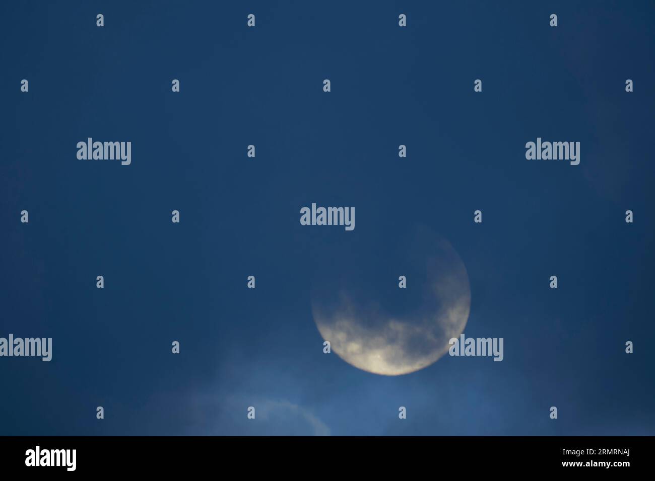 Rushworth, Victoria Australia, 30th August 2023, A blue Moon and the Second Super Moon to appear in the skies in the month of August. Captured on a cloudy evening mostly obscured by clouds to appear briefly when the cloud cover breaks. Credit PjHickox/Alamy Live News Stock Photo