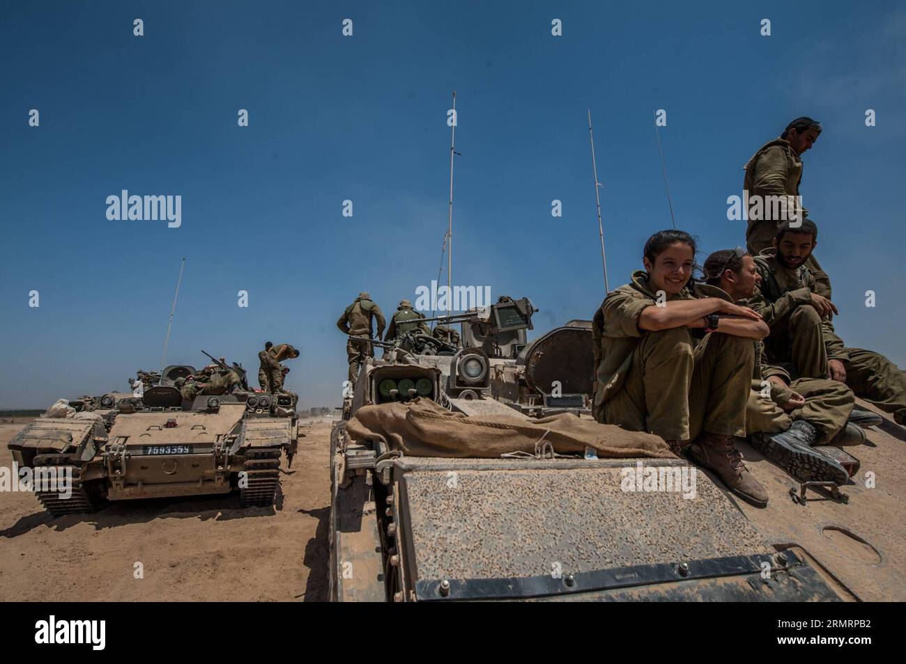 GAZA BORDER, July 30, 2014 -- Israeli soldiers rest on APCs at an army deployment area in southern Israel near the border with Gaza, on July 30, 2014. Three Israeli soldiers were killed in the Gaza Strip on Wednesday, the Israel Defense Forces (IDF) spokesperson unit said in a statement. ) ISRAEL-GAZA-BORDER-FIGHTING-THREE ISRAELI SOLDIERS-KILLED lixrui PUBLICATIONxNOTxINxCHN   Gaza Border July 30 2014 Israeli Soldiers Rest ON APCS AT to Army  Area in Southern Israel Near The Border With Gaza ON July 30 2014 Three Israeli Soldiers Were KILLED in The Gaza Strip ON Wednesday The Israel Defense F Stock Photo