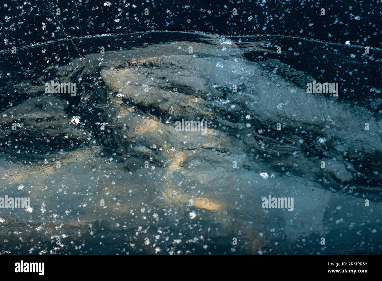 Natural rough frost-covered icy surface of the lake, sea. A frozen ...