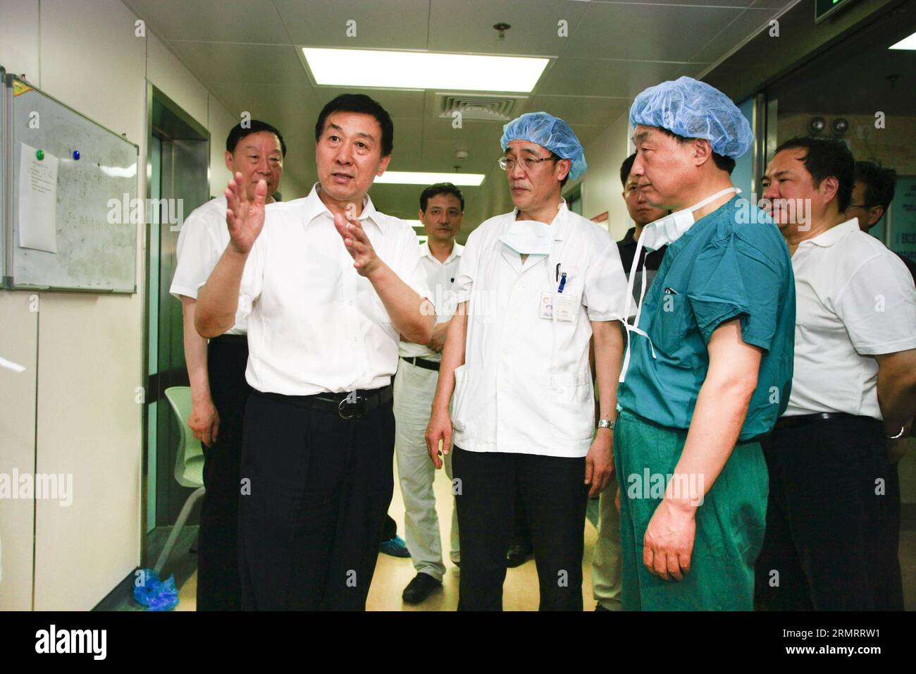 (140802) -- SUZHOU, Aug. 2, 2014 -- Chinese State Councilor Wang Yong (L front) talks with medical staff members at the Second Affiliated Hospital of Soochow University in Suzhou City, east China s Jiangsu Province, Aug. 2, 2014. A powerful factory blast has killed 69 people and injured over 180 others in Kunshan on Saturday morning. Chinese President Xi Jinping and Premier Li Keqiang have assigned Wang Yong to lead a State Council working team to Kunshan to look into the accident. ) (wjq) CHINA-JIANGSU-KUNSHAN-FACTORY BLAST-WANG YONG (CN) ChenxYichen PUBLICATIONxNOTxINxCHN   Suzhou Aug 2 2014 Stock Photo