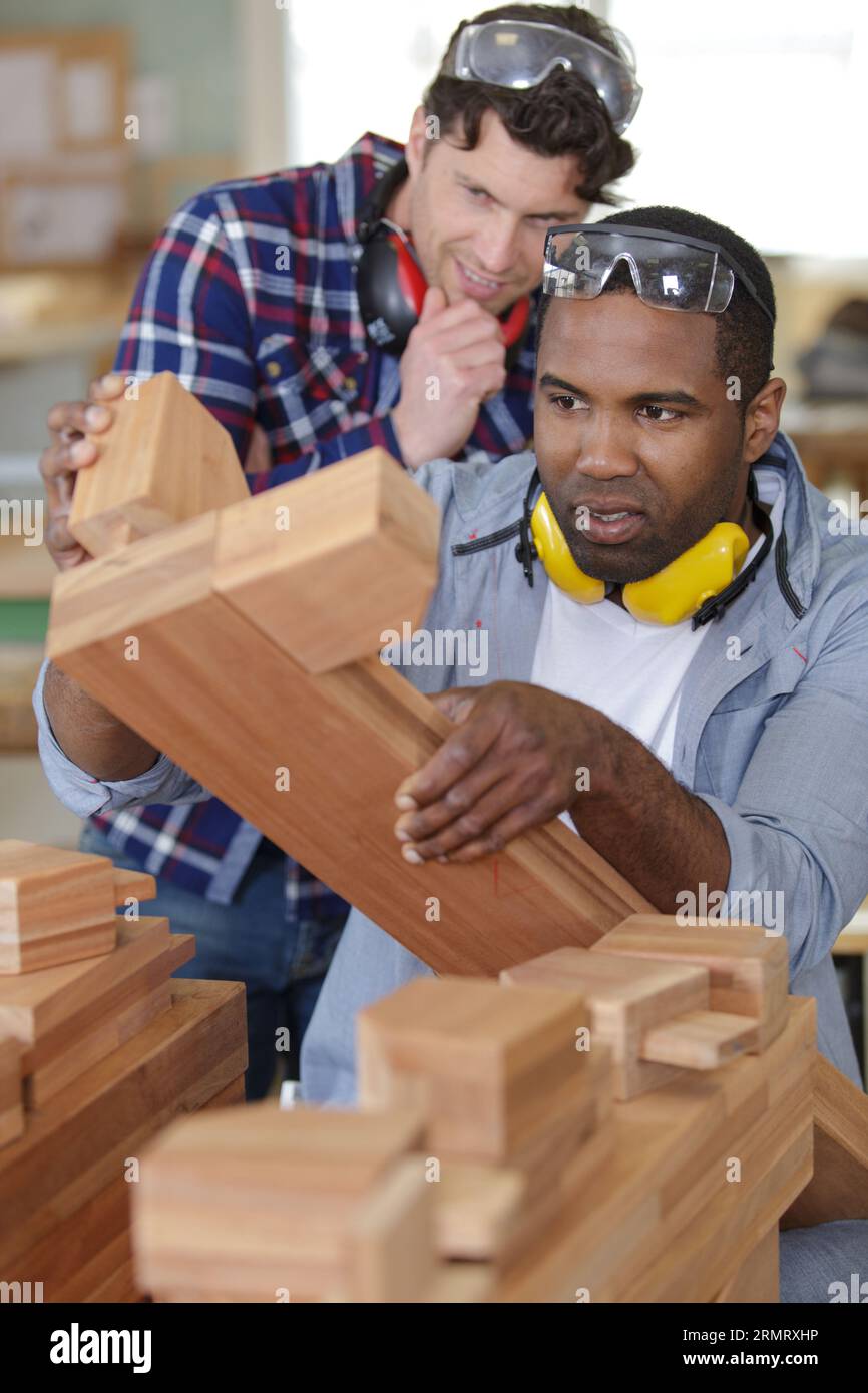 apprentice joiner leaning how to join wood Stock Photo Alamy