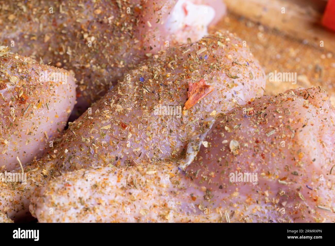 Freshly washed and skinned chicken meat, chicken legs with salt and spices ready for cooking Stock Photo