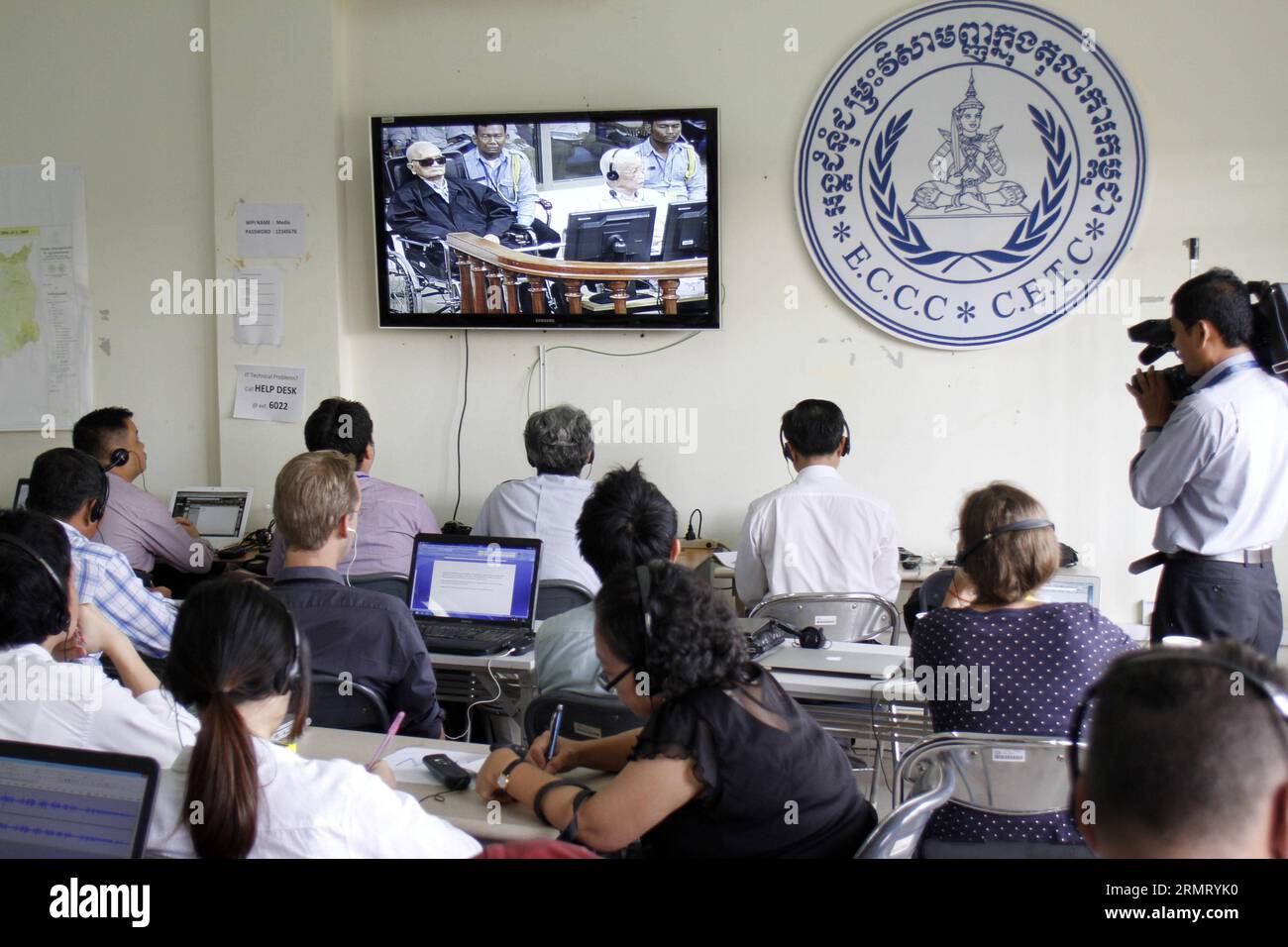(140807) -- PHNOM PENH, Aug. 7, 2014 -- Media members watch the pronouncement of judgment against two aging former top leaders of the Democratic Kampuchea in Phnom Penh, Cambodia, Aug. 7, 2014. The United Nations war crimes tribunal convicted two aging former top leaders of the Democratic Kampuchea, also known as Khmer Rouge, of atrocity crimes against humanity and sentenced them to life in prison, according to a verdict pronounced by the tribunal s president Nil Nonn on Thursday. ) CAMBODIA-PHNOM PENH-VERDICT Sovannara PUBLICATIONxNOTxINxCHN   Phnom Penh Aug 7 2014 Media Members Watch The pro Stock Photo