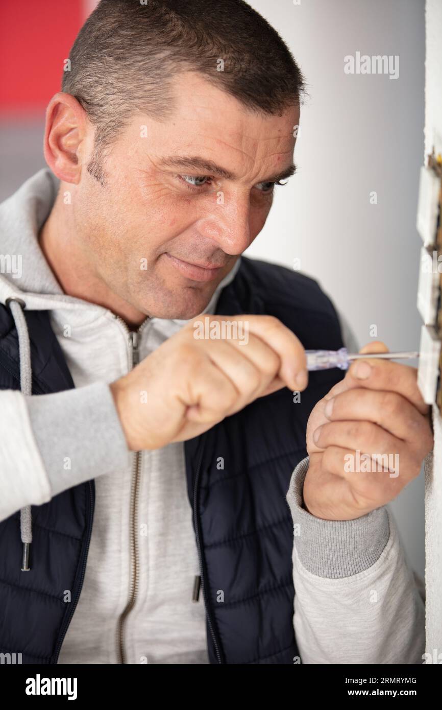 man doing electrical repairs at home Stock Photo