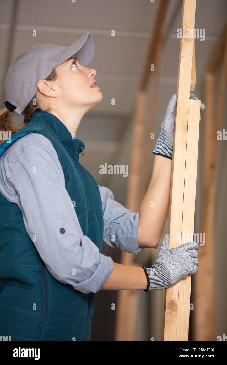 female repairman carpenter with wooden planks Stock Photo