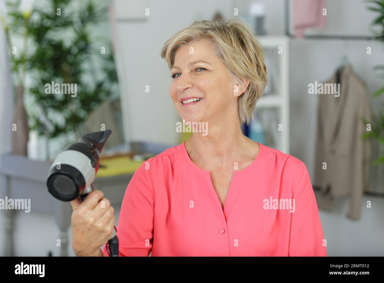 senior woman drying her hair Stock Photo - Alamy