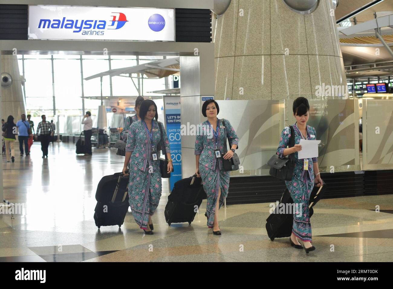 (140808) -- KUALA LUMPUR, Aug. 8, 2014 -- Flight attendants of Malaysia Airlines walk past the Malaysia Airlines counter at the Kuala Lumpur International Airport in Kuala Lumpur, Malaysia, Aug. 8, 2014. Khazanah Nasional Bhd, Malaysia Airlines (MAS) largest shareholder, said on Friday that it sought to delist the national carrier to facilitate its plan to undertake a comprehensive review and restructuring of MAS. ) MALAYSIA-MAS-KHAZANAH NASIONAL BHD-DELIST ChongxVoonxChung PUBLICATIONxNOTxINxCHN   140808 Kuala Lumpur Aug 8 2014 Flight Attendants of Malaysia Airlines Walk Past The Malaysia Air Stock Photo
