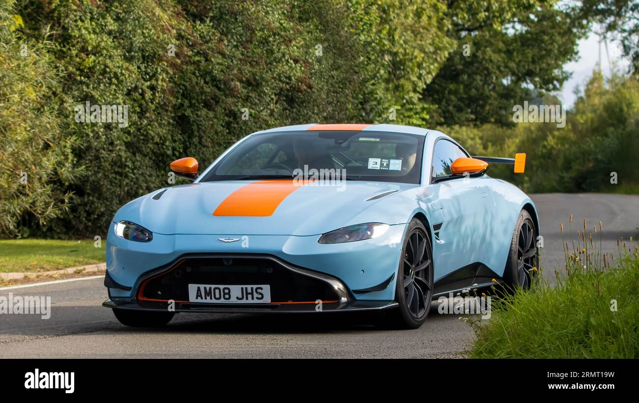 Whittlebury,Northants,UK -Aug 27th 2023: 2021 blue and orange Aston Martin Vantage   car travelling on an English country road Stock Photo