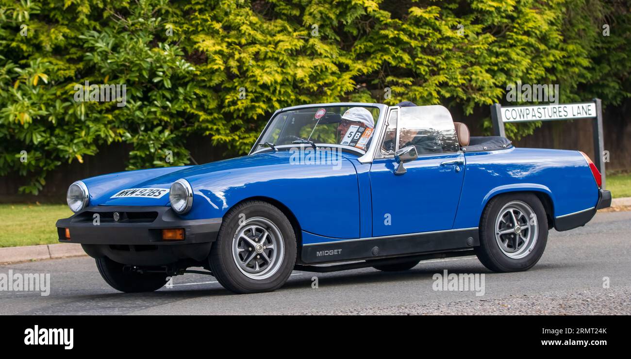 Whittlebury,Northants,UK -Aug 27th 2023: 1977 blue MG Midget 1500  car travelling on an English country road Stock Photo