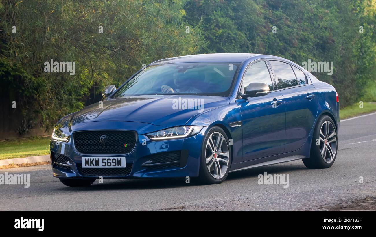 Whittlebury,Northants,UK -Aug 27th 2023: 2016 blue Jaguar XE r-sport car travelling on an English country road Stock Photo