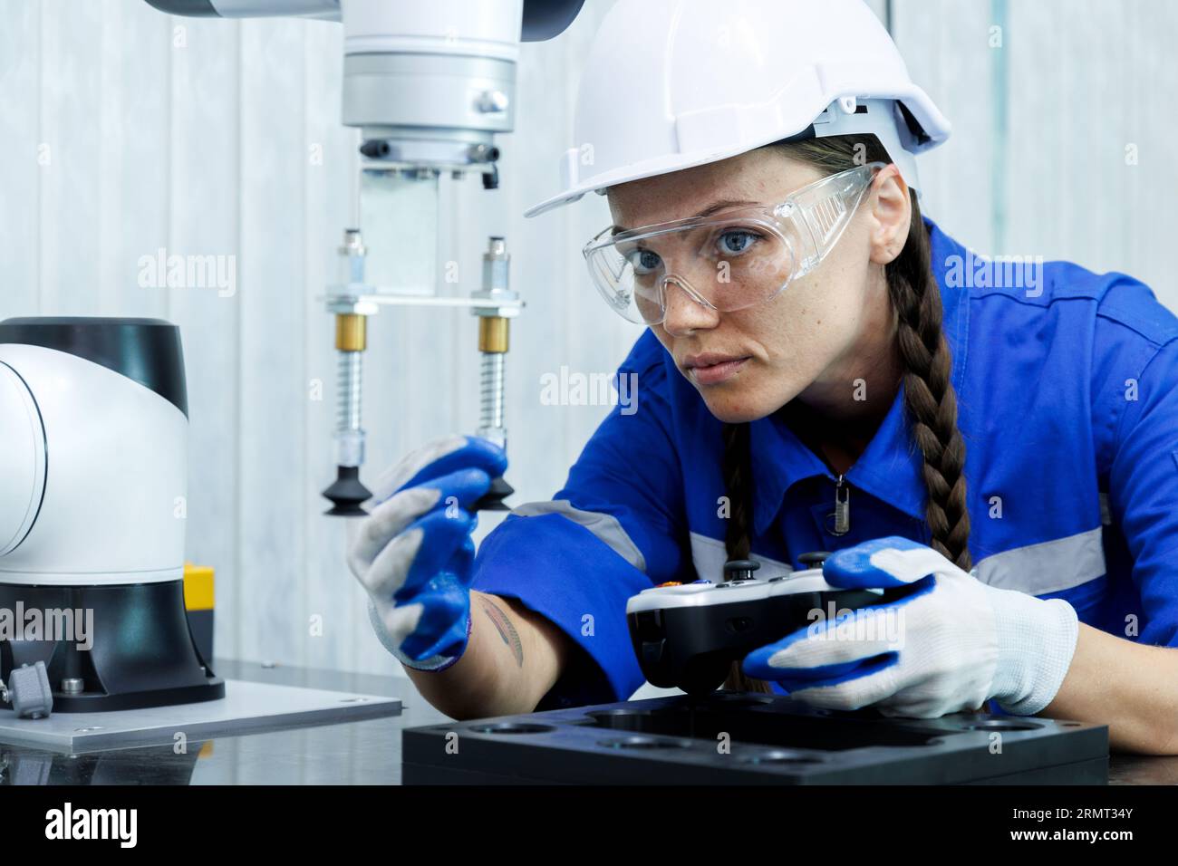 female automation machine engineer student study and inspection control robot arm machine in university or factory workshop. ai robot technology new i Stock Photo
