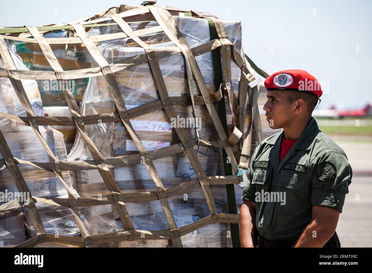 CARACAS, Aug. 12, 2014 -- A Venezuelan soldier watches the supplies for Palestinians at the international airport of Maiquetia, Caracas, Venezuela, on Aug. 12, 2014. Venezuela Tuesday shipped an initial 12 tons of humanitarian aid to the Palestinians stricken with Israel s offensive in the Gaza Strip, the Venezuelan News Agency (AVN) said. Boris Vergara) (da) (sp) VENEZUELA-CARACAS-GAZA-AID e BorisxVergara PUBLICATIONxNOTxINxCHN   Caracas Aug 12 2014 a Venezuelan Soldier Watches The SUPPLIES for PALESTINIANS AT The International Airport of  Caracas Venezuela ON Aug 12 2014 Venezuela Tuesday  t Stock Photo
