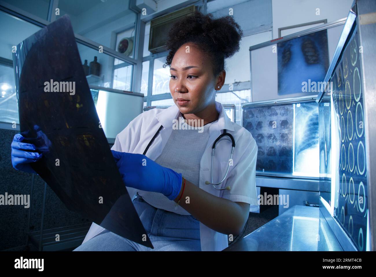 Female medical radiologist doctor looking head and brain xray film