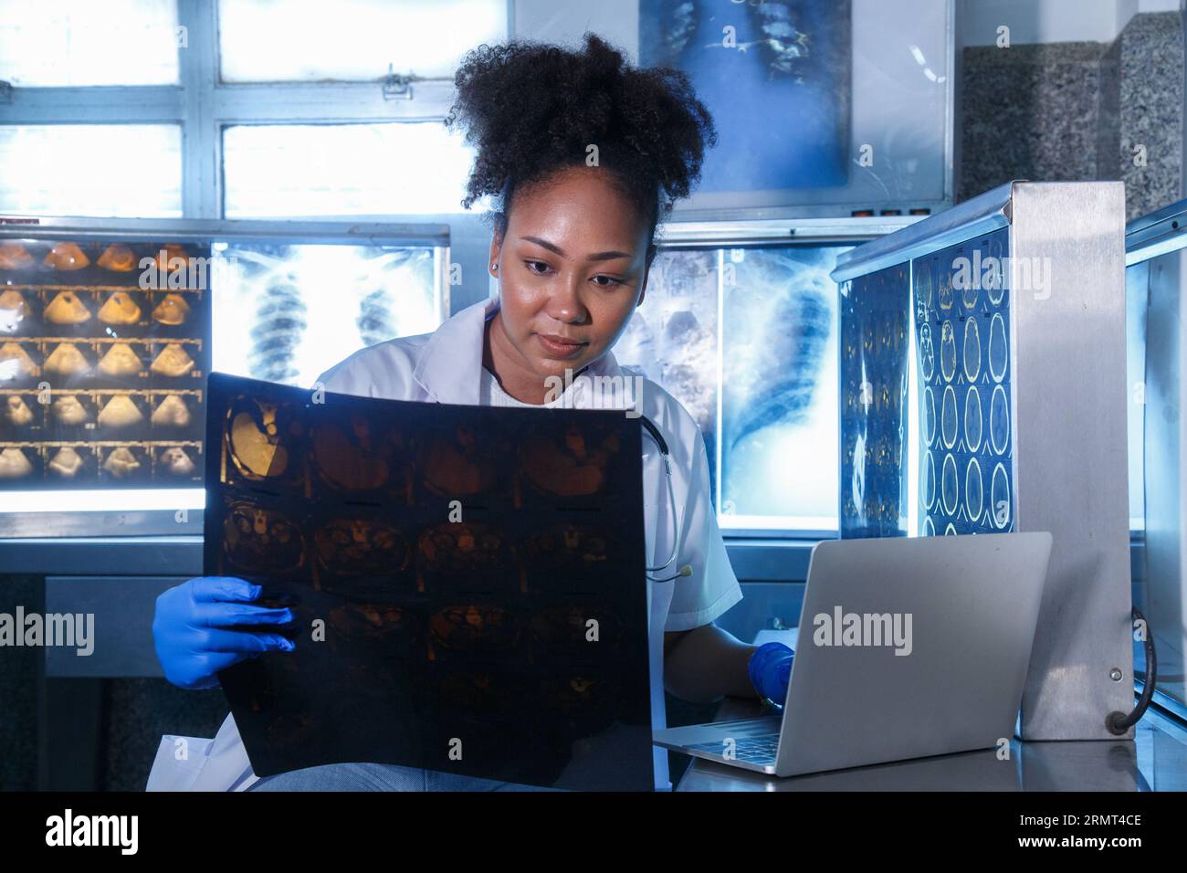 Female medical radiologist doctor looking head and brain xray film