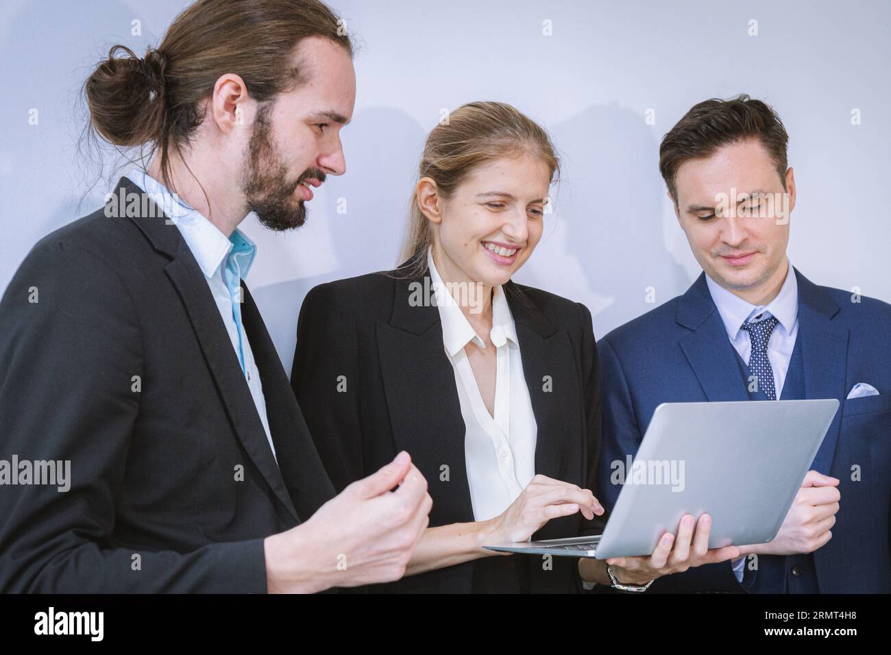 Business team working on master plan. Happy smiling businessman and businesswoman talking about success marketing plan after meeting and presenting to Stock Photo