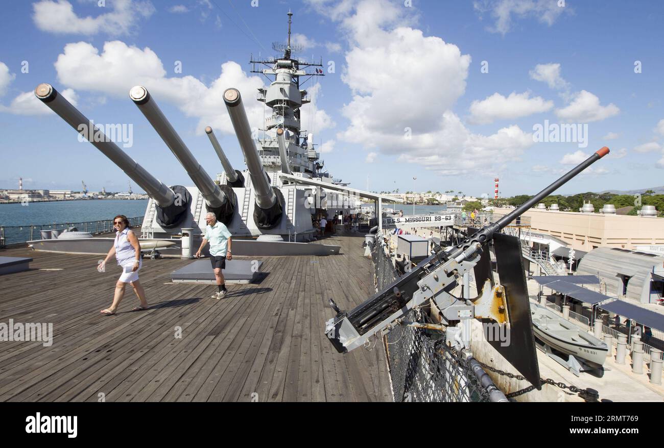 Tourists walk on the deck of the USS Missouri battleship in Pearl ...