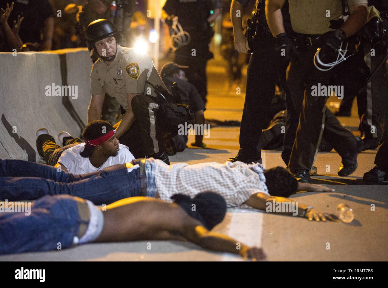 Police officers arrest demonstrators during a protest against police killing of 18-year-old Michael Brown and another 23-year-old black man in Ferguson, Missouri, the United States, on Aug. 19, 2014. A 23-year-old man was shot and killed after he brandished a knife at police officers in northern St. Louis on Tuesday, local authorities said.  dzl US-MISSOURI-FERGUSON-PROTEST-CLASH TingxShen PUBLICATIONxNOTxINxCHN Stock Photo