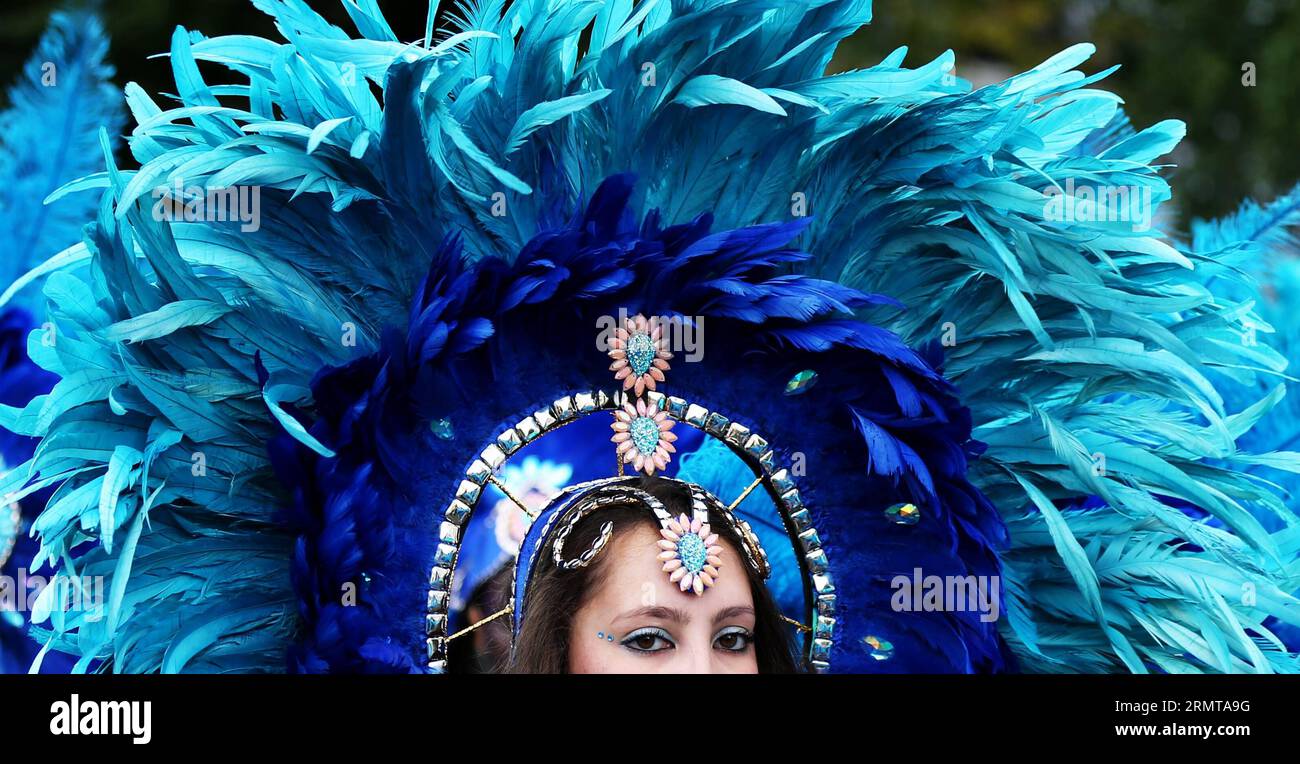 LONDON, Aug. 24, 2014 -- A performer parades through the streets during the Notting Hill Carnival in London, Britain, on August 24, 2014. The Notting Hill Carnival is the largest street festival in Europe and was first held in 1964 by the Afro-Caribbean community. Over the bank holiday weekend, the streets come alive to bands, colourful floats and costumed performers as members of the public flood into the area to join the celebrations. ) UK-LONDON-NOTTING HILL CARNIVAL-CHILDREN S DAY PARADE HanxYan PUBLICATIONxNOTxINxCHN   London Aug 24 2014 a Performer Parades Through The Streets during The Stock Photo