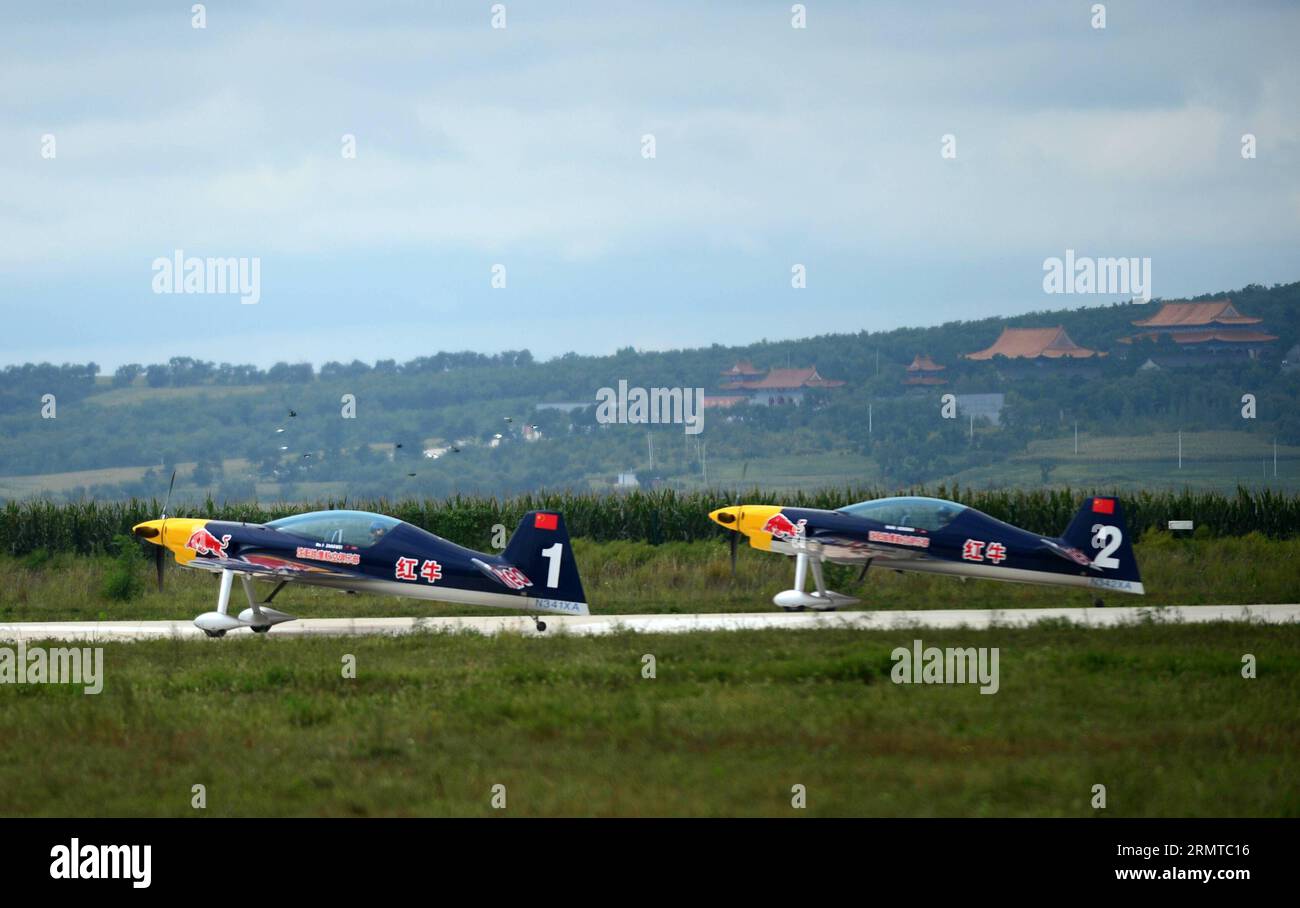 Members of the Red Bull Aerobatic Team of China take part in a training in Faku, northeast China s Liaoning Province, Aug. 25, 2014. The Red Bull Aerobatic Team of China, the nation s first unlimited aerobatics team, was founded by professional pilot Zhao Wei on Sept. 20 of 2013. Besides Zhao, members of the team are all from South Africa. The team has four XA 42 planes, the top-level aerobatic planes which allow a pilot to fly at much lower altitudes and slower speeds and hence provide a much stronger visual impact for spectators. The aerobatic team is preparing for the World Advanced Aerobat Stock Photo