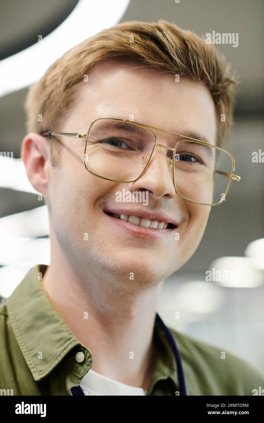 professional headshot of businessman in eyeglasses looking at camera in modern office Stock Photo