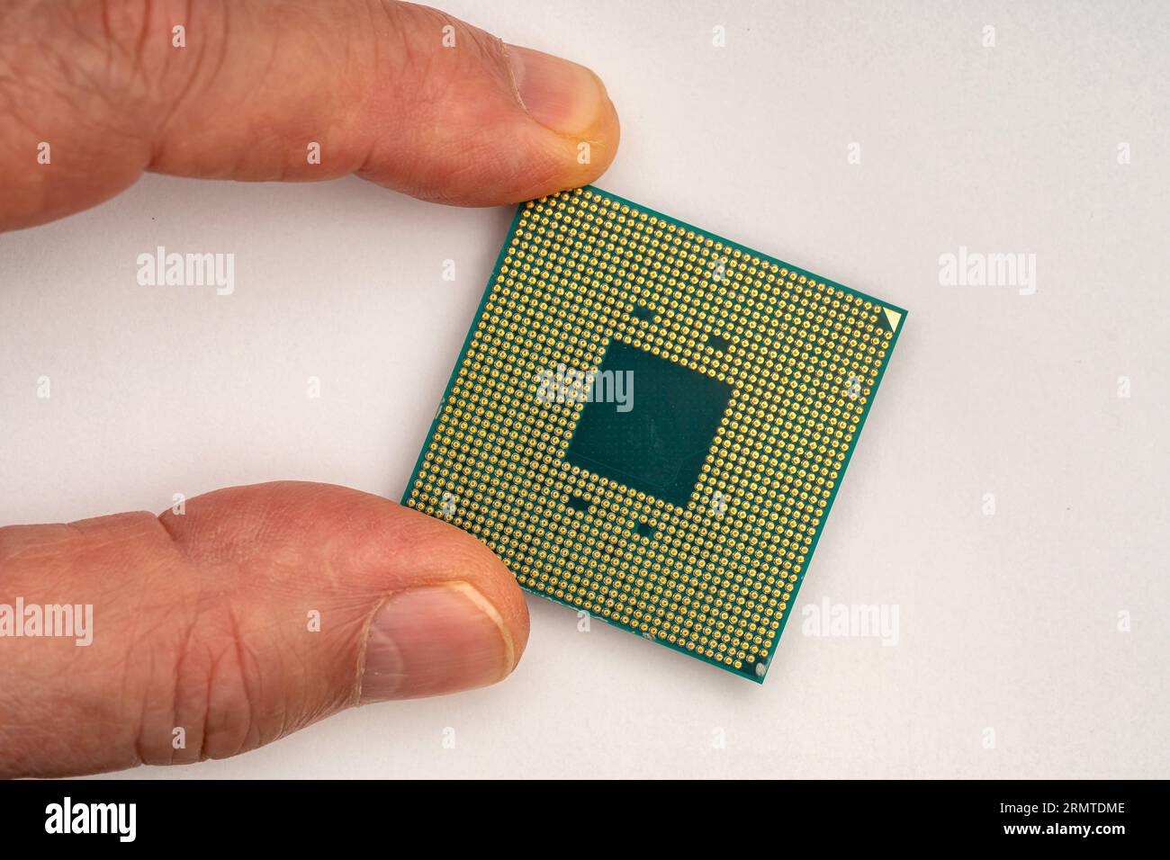 CPU. Hand of a person holding a computer processor close-up. Stock Photo