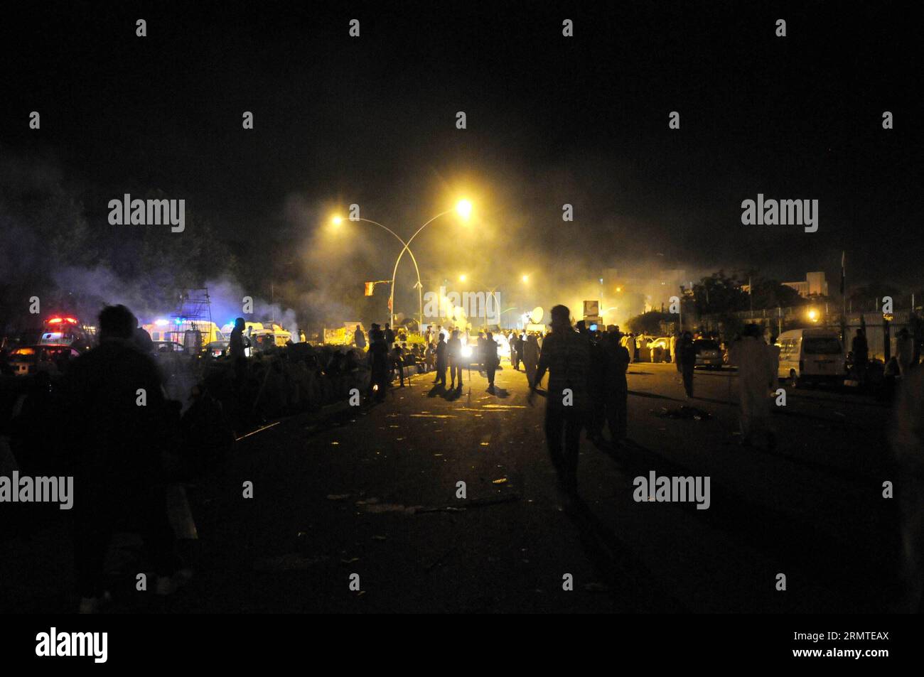 (140831) -- ISLAMABAD, Aug. 31, 2014 -- Pakistani protesters disperse following clashes with security forces near the prime minister s residence in Islamabad, capital of Pakistan on Aug. 31, 2014. At least 450 people were injured when clashes broke out between police and protesters after a 17- day long peaceful sit-in in Pakistan s capital city of Islamabad on Saturday night, local media reported Sunday. ) PAKISTAN-ISLAMABAD-PROTEST-CLASHES AhmadxKamal PUBLICATIONxNOTxINxCHN   Islamabad Aug 31 2014 Pakistani protesters  following clashes With Security Forces Near The Prime Ministers S Residenc Stock Photo
