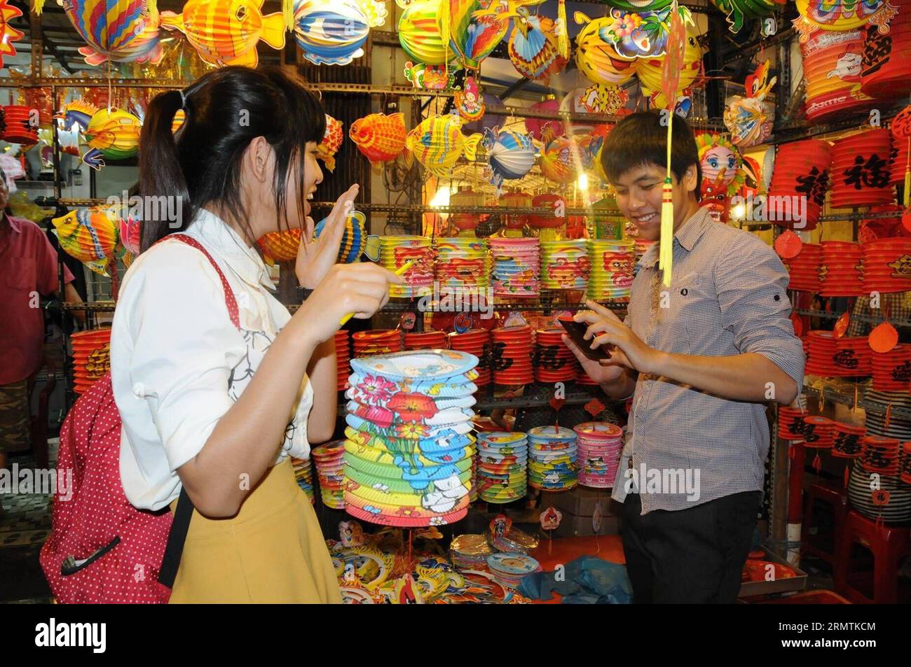 A girl poses for pictures during a visit to the Lantern Street in Ho Chi Minh City, on Sept. 8, 2014. The Mid-Autumn festival is one of the biggest celebrations of the year in Vietnam. ) VIETNAM-HO CHI MINH CITY-MID-AUTUMN FESTIVAL-LANTERN TaoxJun PUBLICATIONxNOTxINxCHN   a Girl Poses for Pictures during a Visit to The Lantern Street in Ho Chi Minh City ON Sept 8 2014 The Mid Autumn Festival IS One of The Biggest celebrations of The Year in Vietnam Vietnam Ho Chi Minh City Mid Autumn Festival Lantern  PUBLICATIONxNOTxINxCHN Stock Photo