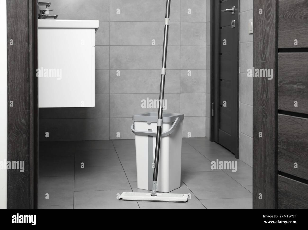 Mop and bucket in public toilet. Cleaning floor Stock Photo Alamy