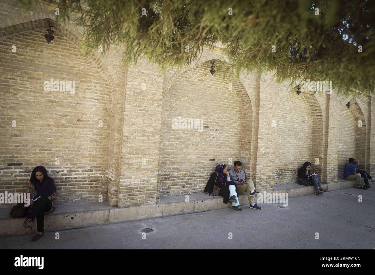 SHIRAZ, Sept. 26, 2014 -- People read poems of Hafez as they sit around the tomb of Persian mystic poet Hafez in southern city of Shiraz on Sept. 26, 2014. Hafez collected poems are regarded as a pinnacle of Persian literature and are to be found in the homes of most people in Iran and Afghanistan. ) (cy) IRAN-SHIRAZ-CULTURE-HAFEZ AhmadxHalabisaz PUBLICATIONxNOTxINxCHN   Shiraz Sept 26 2014 Celebrities Read Poems of Hafez As They Sit Around The Tomb of Persian Mystic Poet Hafez in Southern City of Shiraz ON Sept 26 2014 Hafez collected Poems are regarded As a Pinnacle of Persian Literature and Stock Photo