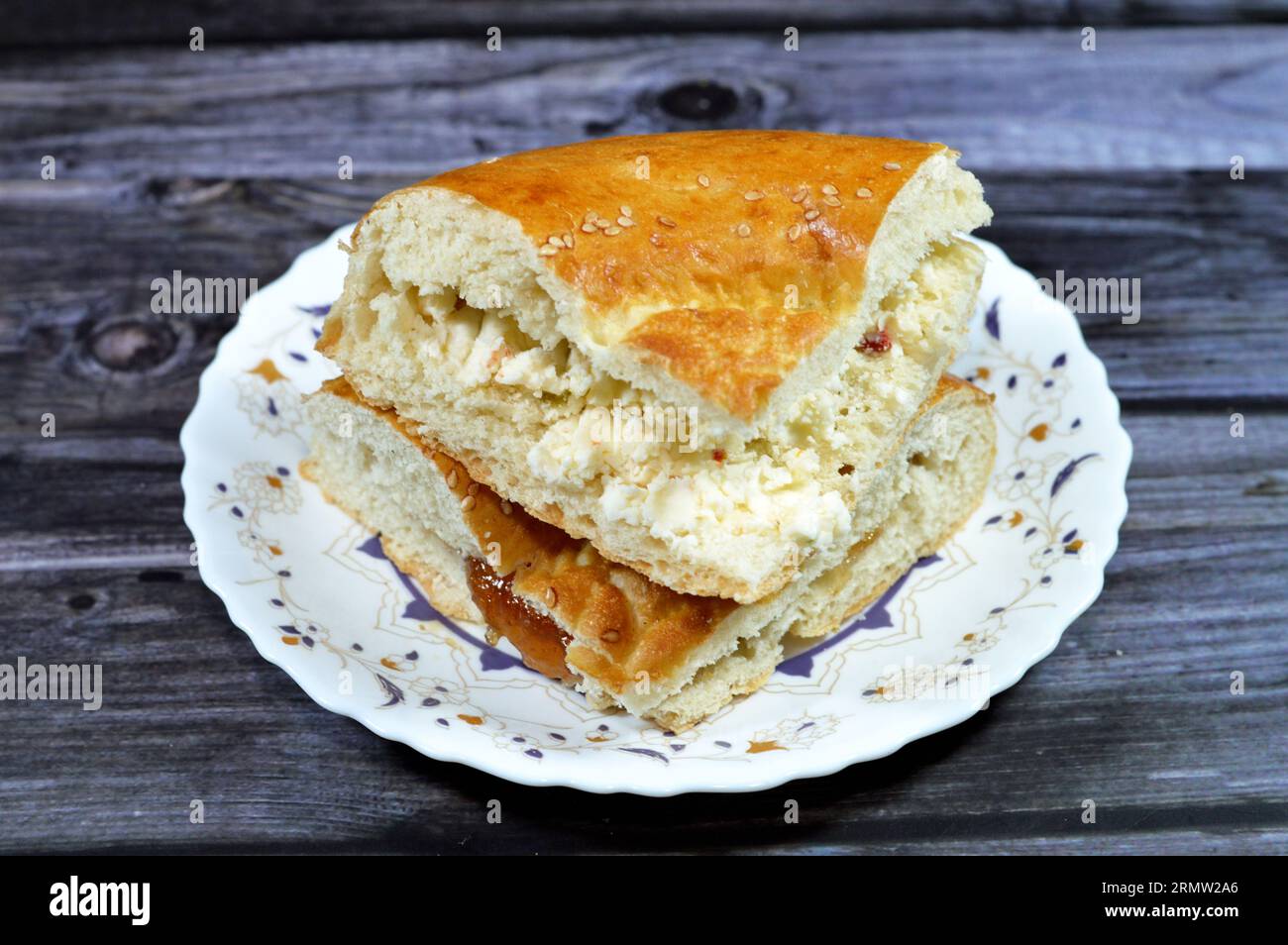 White cheese and fig jam inside a tandyr nan Uzbek bread, a type of Central Asian bread, often decorated by stamping patterns on the dough by using a Stock Photo