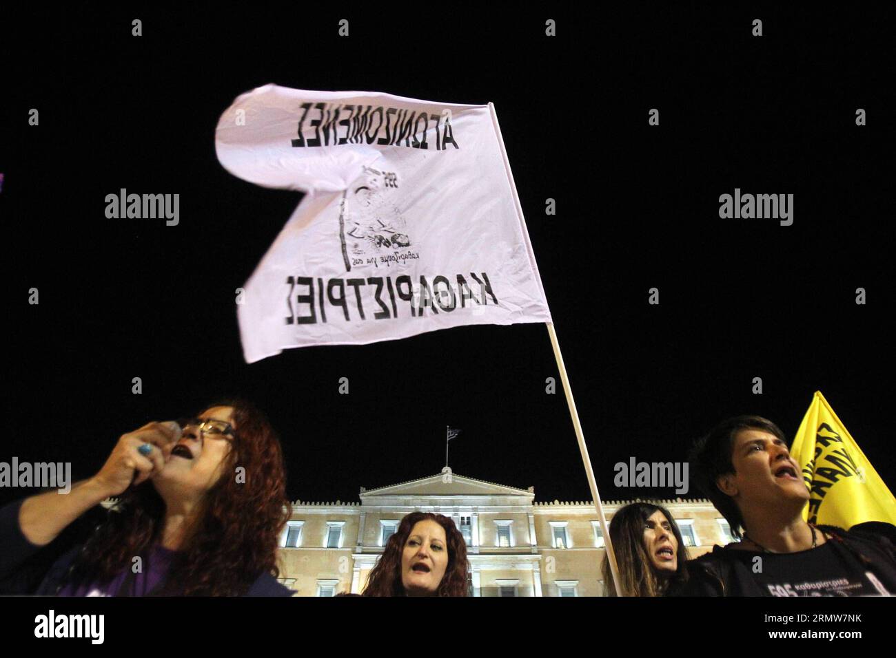 Protestors shout slogans outside the Greek Parliament building during a rally in Athens, Greece, Oct. 10, 2014. Greek Parliament will vote Friday on a confidence motion proposed by Greek Government. According to local political analysts, the government is expected to easily win the roll-call vote sought by Greek Prime Minister Antonis Samaras in an effort to halt early general elections. ) GREECE-ATHENS-POLITICS-CONFIDENCE-VOTE MariosxLolos PUBLICATIONxNOTxINxCHN   protestors Shout Slogans outside The Greek Parliament Building during a Rally in Athens Greece OCT 10 2014 Greek Parliament will V Stock Photo