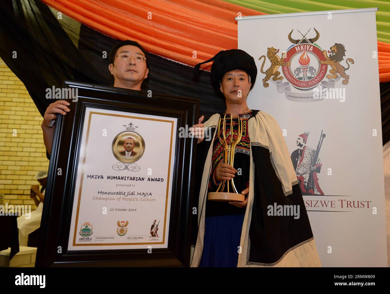 Jike Qubu (R), a student and representive of Jidi Majia who is a Chinese poet and winner of the 2014 Mkiva Humanitarian Awards, attends the awarding ceremony at Walter Sisulu University Butterworth Campus in Eastern Cape, South Africa, on Oct. 10, 2014. The Mkiva Humanitarian Awards celebrates the efforts and successes of African and International leaders who have made an impact on local or international communities. This year s recipients include: Jidi Majia of China, Saeb Erekat of Palestine, Queen Best Kemigisa of Uganda and Rebecca Malope, Mzimasi Mnguni and Mthetheleli NgumbelaThe of Sout Stock Photo