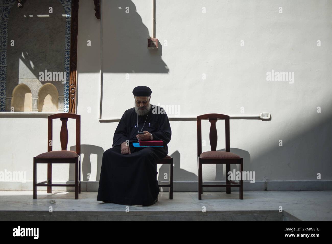 A Coptic priest rests at the hanging Coptic church in Cairo, Egypt, Oct. 11, 2014. The centuries-old church was reopened on Oct. 11 after 16 years of renovation. ) EGYPT-CAIRO-RELIGION-COPTIC CHURCH PanxChaoyue PUBLICATIONxNOTxINxCHN   a Coptic Priest rests AT The Hanging Coptic Church in Cairo Egypt OCT 11 2014 The centuries Old Church what reopened ON OCT 11 After 16 Years of Renovation Egypt Cairo Religion Coptic Church  PUBLICATIONxNOTxINxCHN Stock Photo