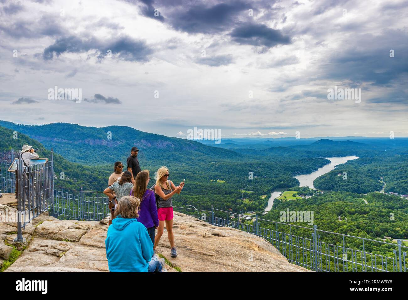 Chimney Rock, North Carolina, USA - August 11, 2023: Tourst at the top of Chimney Rock at Chimney Rock State Park. Stock Photo