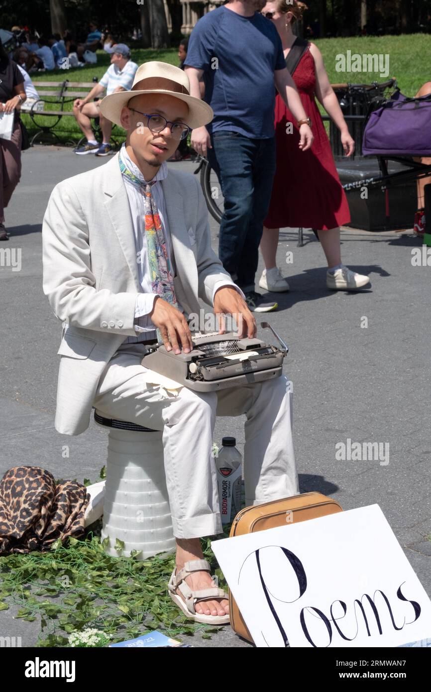 An Asian American man in Washington Square Park writes personal poems and solicits donations. In August, 2023 in Manhattan. Stock Photo