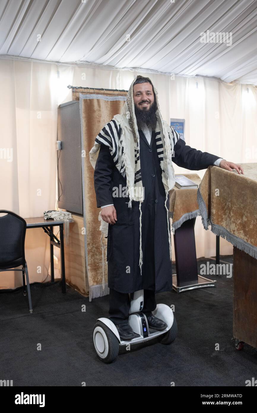 A sexton shammash at a synagogue with a few tents. His hoverboard