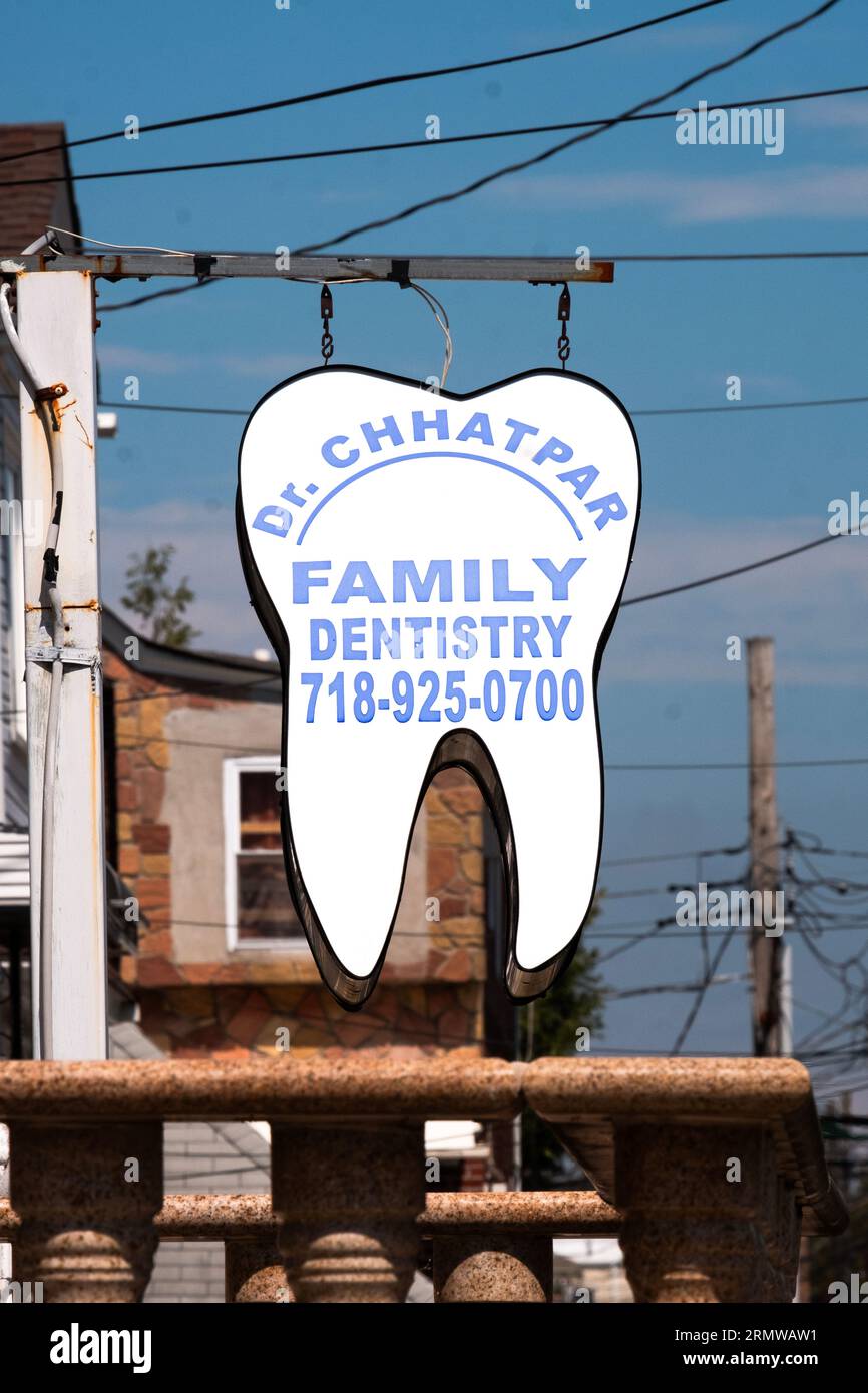 A sign in the shape of a tooth for dentist Dr. Chhatpar on 127th Street in South Richmond Hill, Queens, New York. Stock Photo