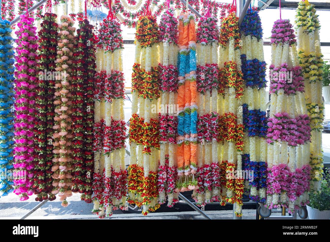 Colorful strings of garlands outside a store that sells clothing and