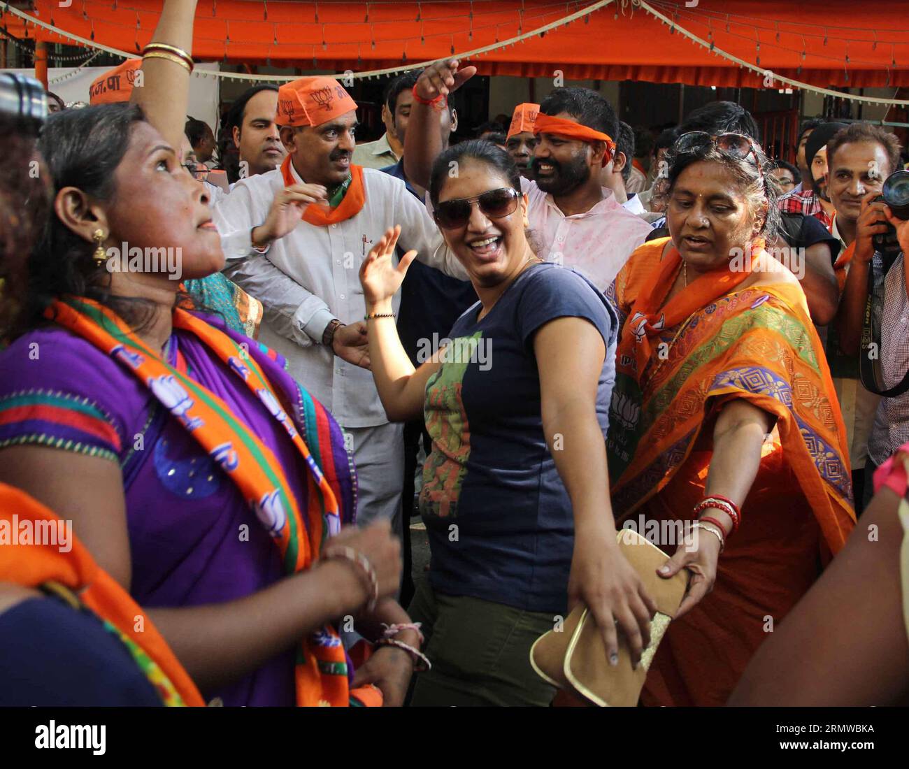 (141019) -- MUMBAI, Oct. 19, 2014 -- Supporters of India s ruling Bharatiya Janata Party (BJP) celebrate as early results indicated the party leading in the Maharashtra state assembly elections in Mumbai, India, Oct. 19, 2014. India s ruling Bharatiya Janata Party (BJP) has won control of the country s financial capital Mumbai through a legislative election in the state of Maharashtra, while also grasping the northern state of Haryana from the Congress, said vote counting results Sunday. ) INDIA-MUMBAI-BJP-CELEBRATION Stringer PUBLICATIONxNOTxINxCHN   Mumbai OCT 19 2014 Supporters of India S r Stock Photo