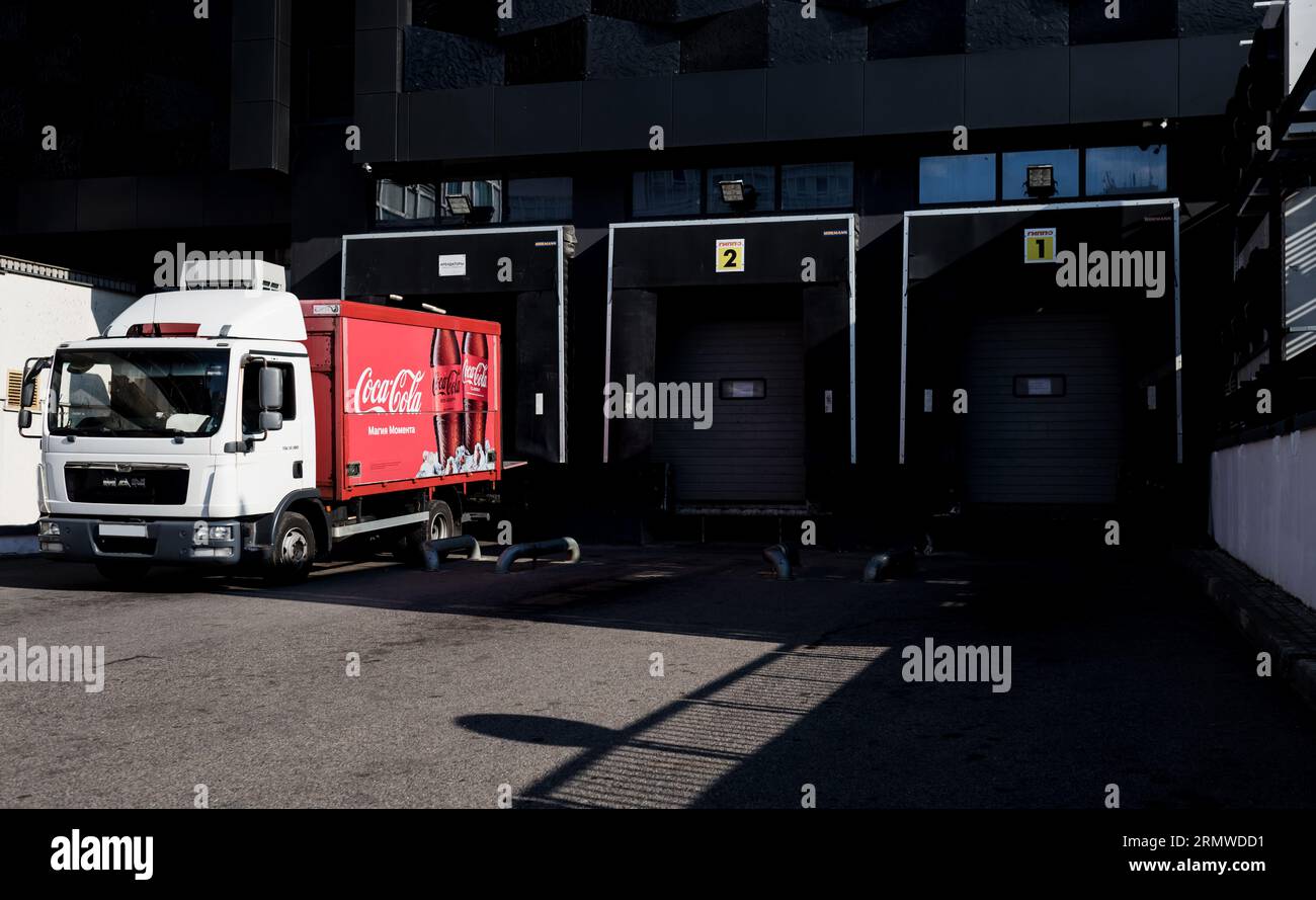 Minsk, Belarus, August 2023 - Red Coca-Cola truck parked and unload the stocks Stock Photo