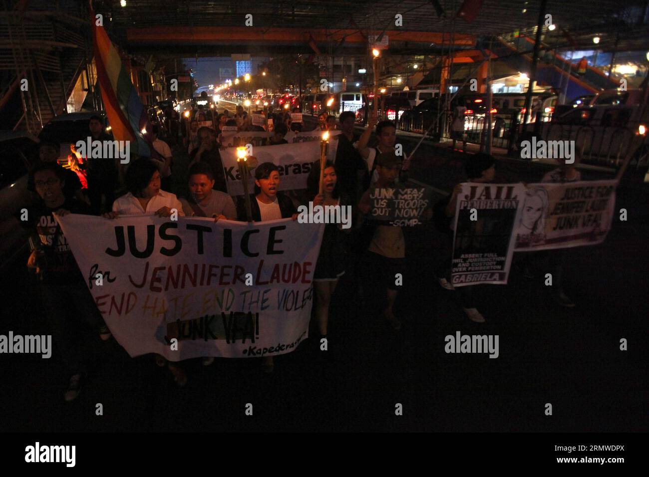 Activists hold torches as they call for justice during a protest rally ...