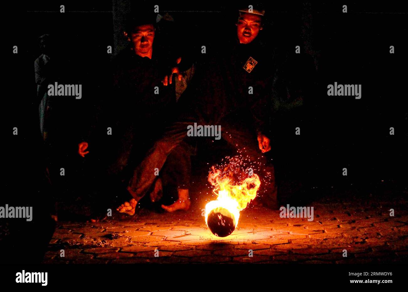 People play fire football to celebrate on the eve of Islamic New Year ...