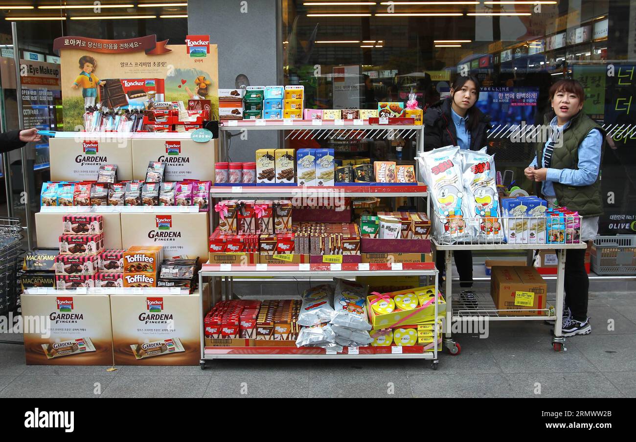 Saleswomen stand beside pepero chocolate sticks and other candies at a grocery store in Seoul, South Korea, Nov. 11, 2014. Pepero Day is celebrated annually on Nov. 11 in South Korea, with stores selling pepero chocolate sticks and single people trying to find their Mr or Mrs Rights. ) SOUTH KOREA-PEPERO DAY-SALE YaoxQilin PUBLICATIONxNOTxINxCHN   stand Beside  Chocolate Sticks and Other Candies AT a Grocery Store in Seoul South Korea Nov 11 2014  Day IS celebrated annually ON Nov 11 in South Korea With Stores Selling  Chocolate Sticks and Single Celebrities trying to find their Mr or Mrs Righ Stock Photo