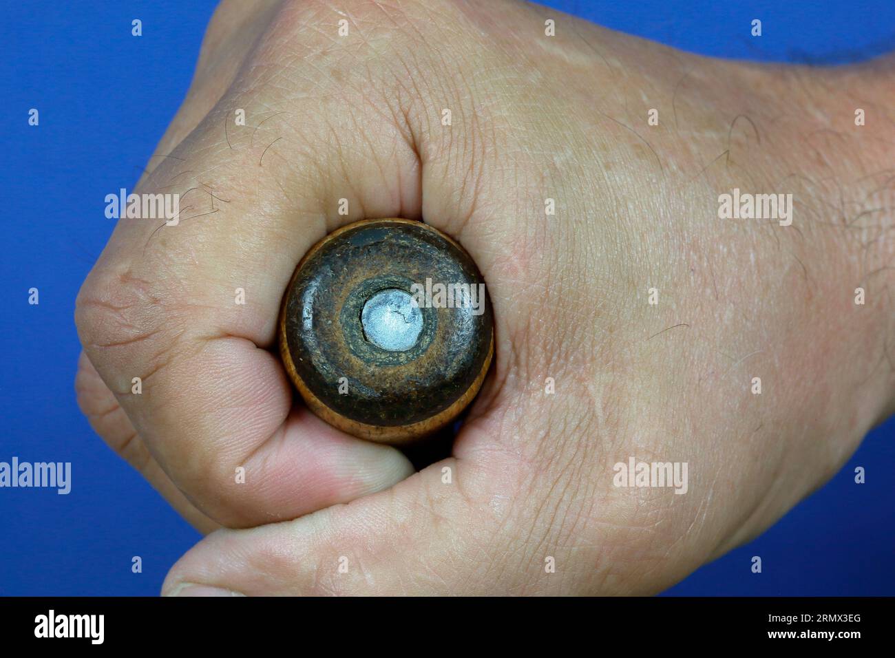 Everything firmly under control. Craftsman holds the handle of a screwdriver tightly in his fist. Stock Photo